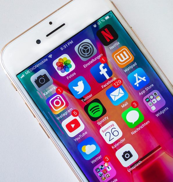 Smartphone home screen displaying social media and utility apps including Instagram, Twitter, Facebook, YouTube, Mail, and Spotify.