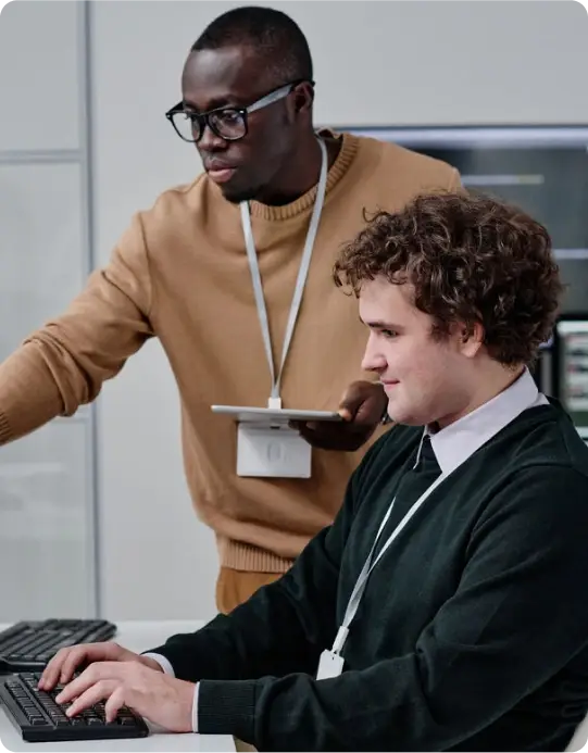 Two IT managers reviewing incident management policies on trusted devices with Duo.