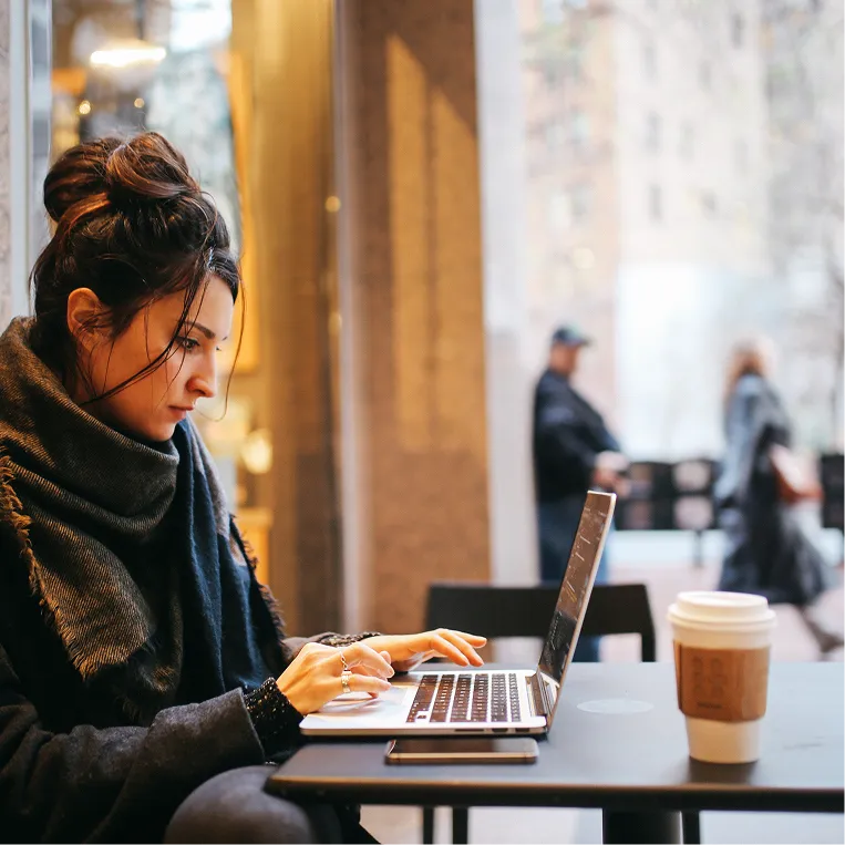 Remote worker using her laptop as a trusted device using Duo's remote access