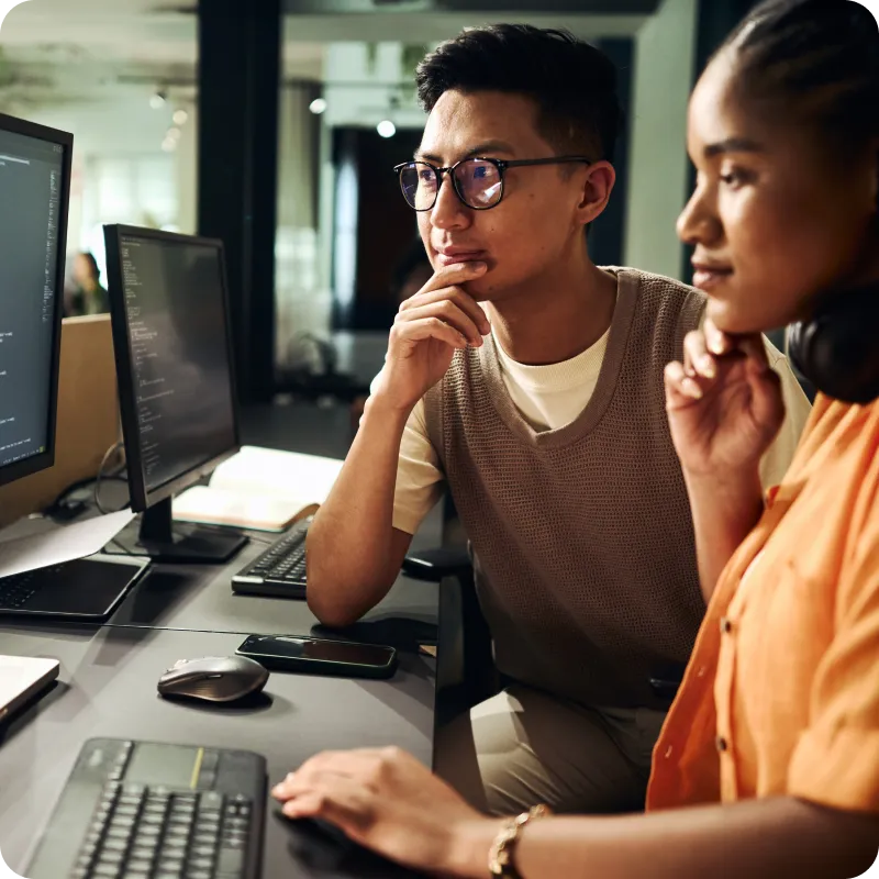 Two people looking at screen