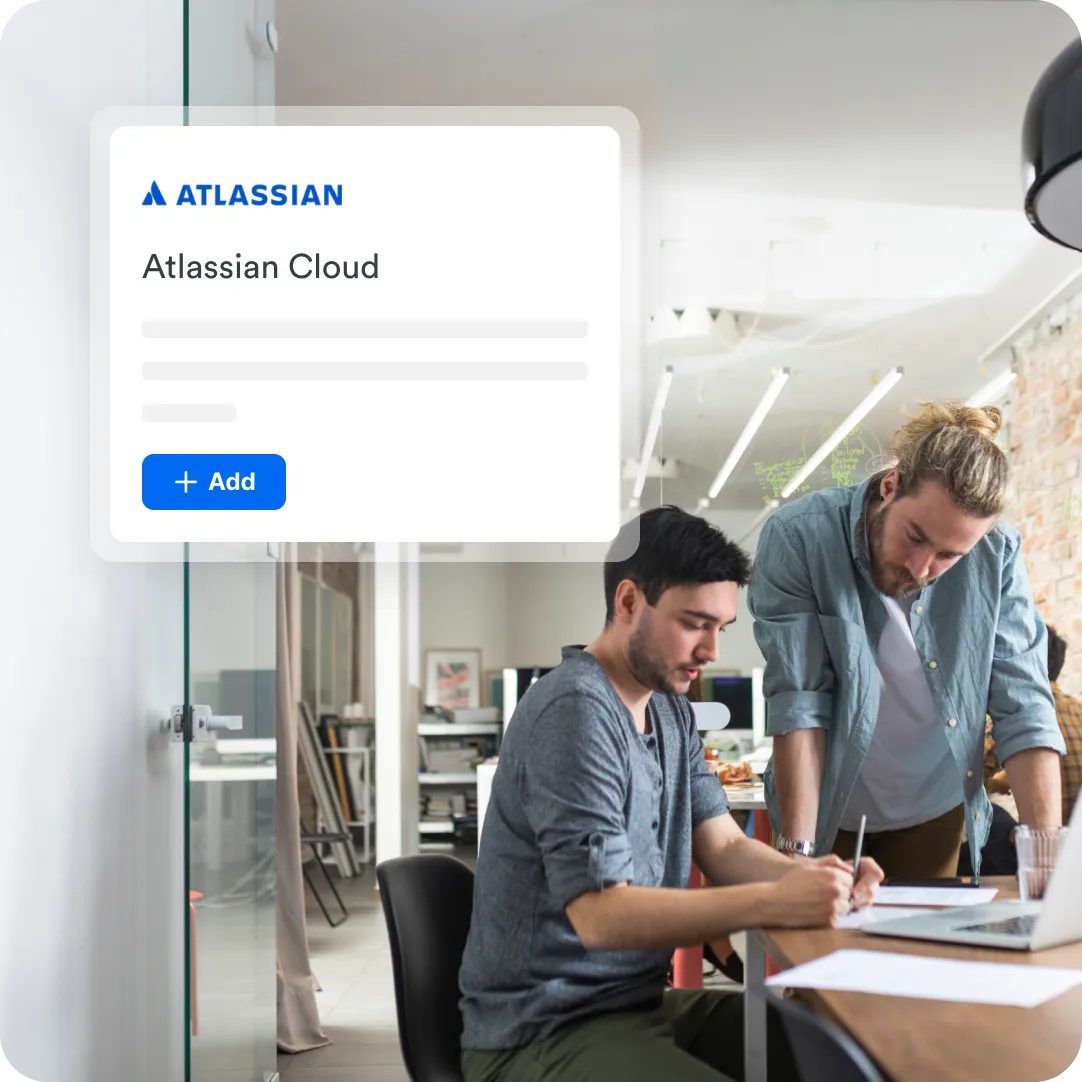 Two coworkers at a desk with Atlassian Cloud integration prompt in the foreground to showcase SSO integrations with Duo.