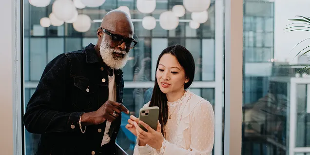 Two remote workers using Duo MFA support on trusted device